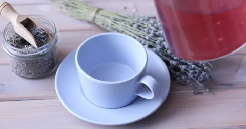 Pouring lavender tea into a cup Stock-Footage 103419000