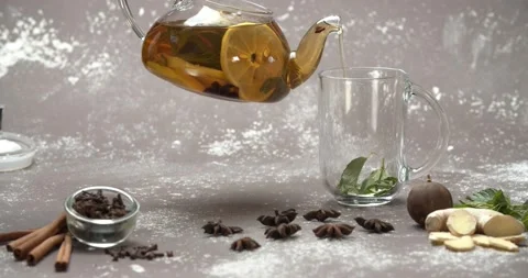 Pouring lemon tea from teapot into mint cup, slow motion Stock Footage 142998675