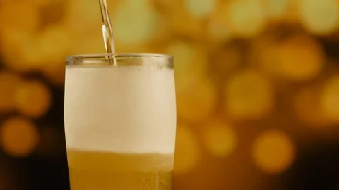 Pouring light beer into glass. Stock Footage 88610907