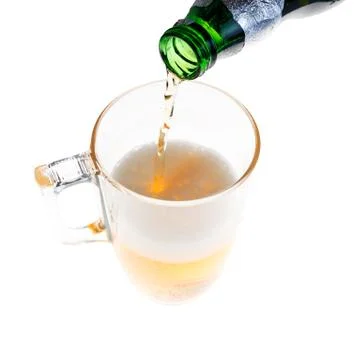 Pouring light beer in the mug Фото