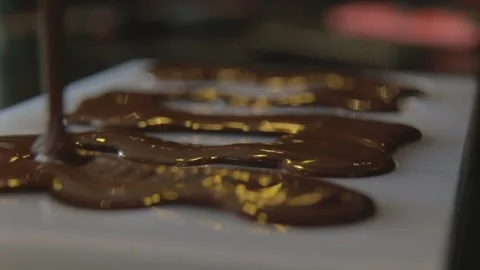 Pouring liquid chocolate intos shape Stock Footage 229718635