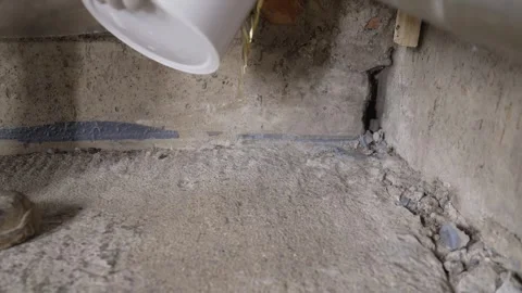 Pouring liquid on concrete floor Stock Footage 336977993