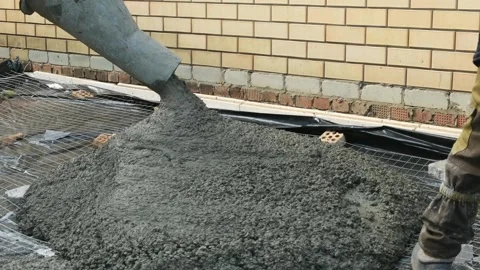 Pouring liquid concrete slab at a construction site. Cement truck pouring Stock Footage 285706526