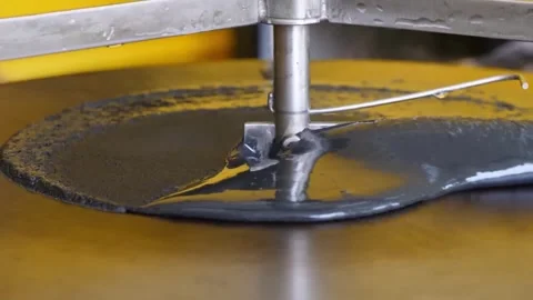 Pouring Liquid Crepe Batter Onto a Professional Hot Griddle in Close-Up Video stock 345692653