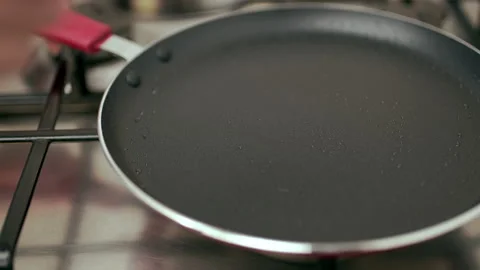 Pouring liquid dough into a pan. Concept of making French Crepes or Pancakes. Video stock 133596129