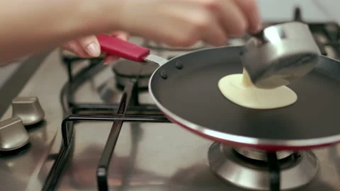 Pouring liquid dough into a pan. Concept of making French Crepes or Pancakes. Stock Footage 133596412