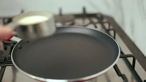 Pouring liquid dough into a pan. Concept of making French Crepes or Pancakes. Video stock 133596446