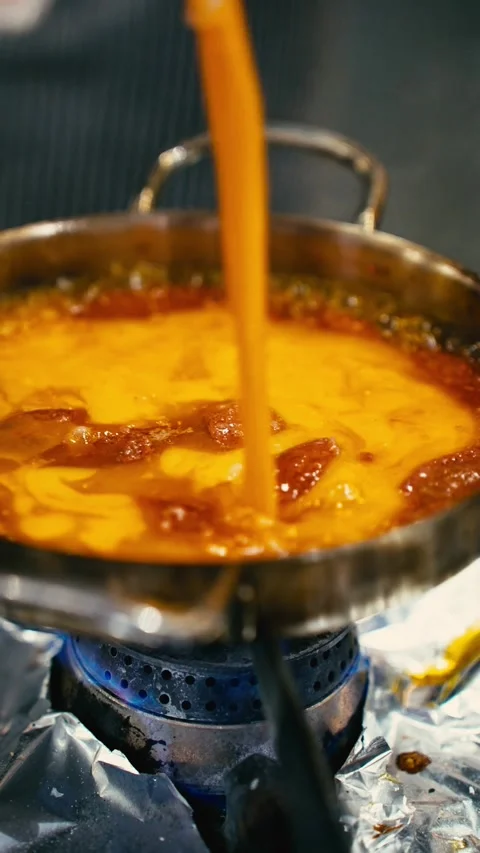 Pouring Liquid Egg Mix over Frying Spicy Turkish Sausage in Pan Stock Footage 341014065