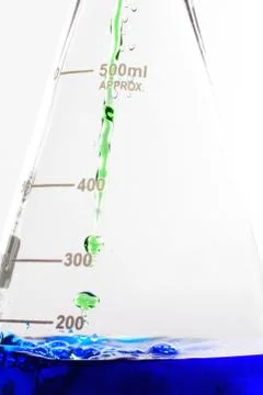Pouring liquid into flask Stock Photos