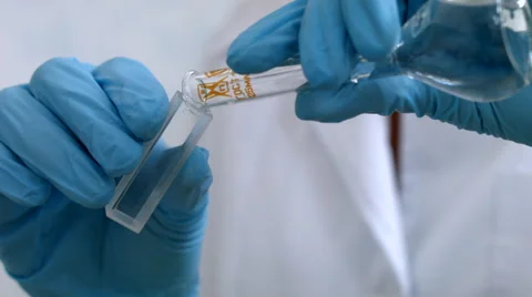 Pouring liquid into narrow flask in laboratory 動画素材 52030561