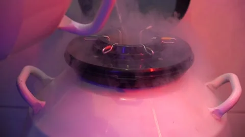 Pouring liquid nitrogen in to the container with semen samples. Stock Footage 142438898