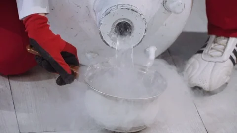 Pouring liquid nitrogen into the pan Stock Footage 120503148
