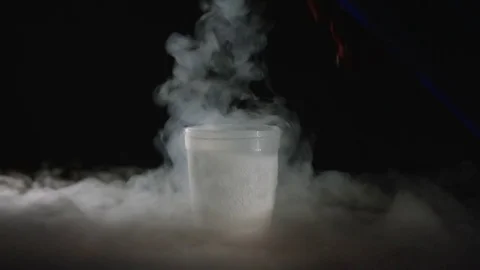 Pouring liquid nitrogen in plastic cup Stock Footage 72950233