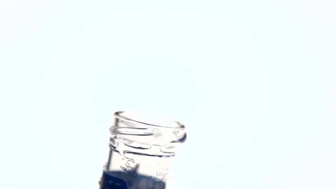 Pouring liquid from one beaker to another Stock-Footage 72569351