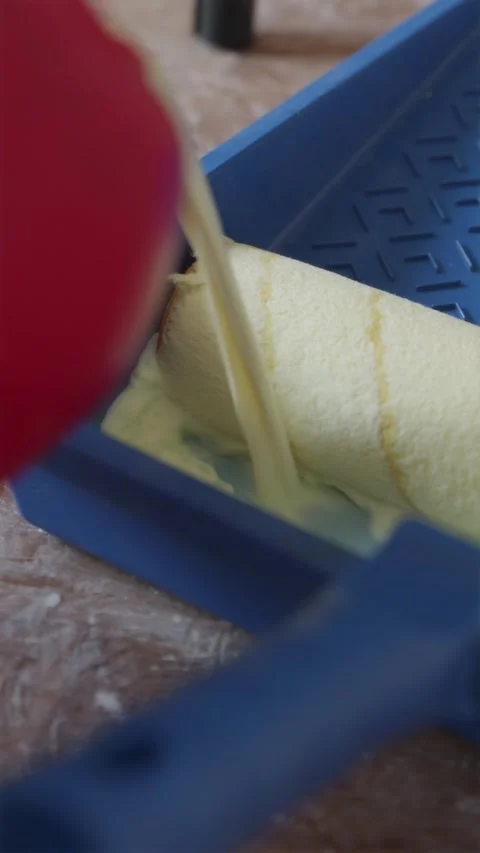 Pouring liquid primer into plastic paint tray with paint roller Stock Footage 340404977