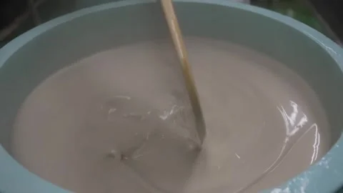 Pouring Liquid Starch Batter Into a Basin at a Sweets Factory Stock Footage 340009432