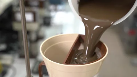 Pouring liquid through a fine mesh filter is a crucial step in beverage Stock Footage 300489500