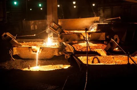 Pouring liquid titanium slag from arc furnace Stock Photos