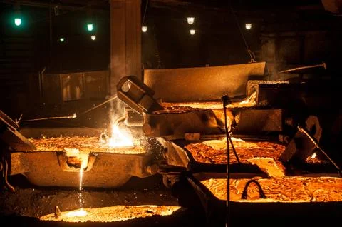 Pouring liquid titanium slag from arc furnace Stock Photos