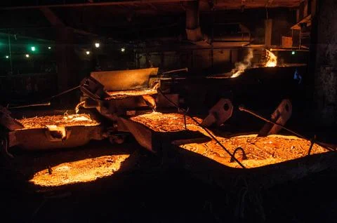 Pouring liquid titanium slag from arc furnace Stock Photos