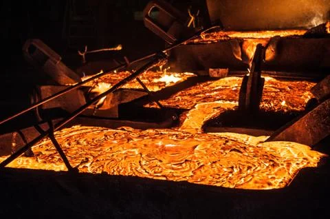 Pouring liquid titanium slag from arc furnace Stock Photos