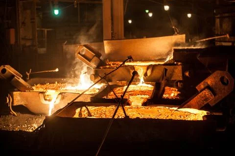 Pouring liquid titanium slag from arc furnace Stock Photos