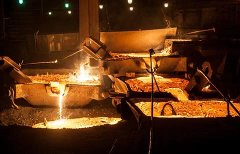 Pouring liquid titanium slag from arc furnace Stock Photos