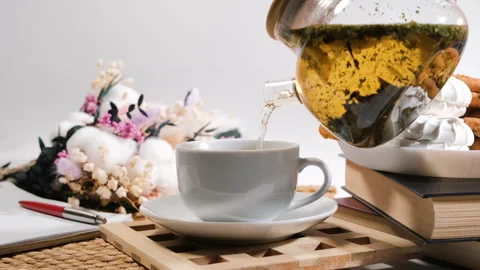 Pouring loose leaf tea with lemon slice into cup Stock Footage 317297400