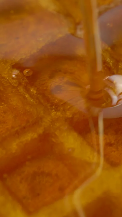 Pouring maple syrup on delicious Belgian golden waffles Stock Footage 305208514