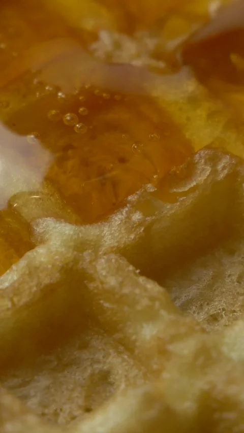 Pouring maple syrup on delicious Belgian golden waffles Stock Footage 317092651