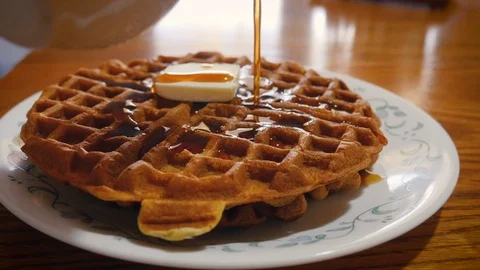 Pouring Maple Syrup onto a Golden Brown Waffle at Brunch in 4k Stock Footage 86486564