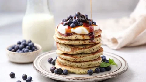 Pouring maple syrup on stack of pancakes Stock Footage 157487405
