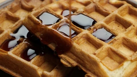 Pouring maple syrup on waffles macro Video stock 168717099