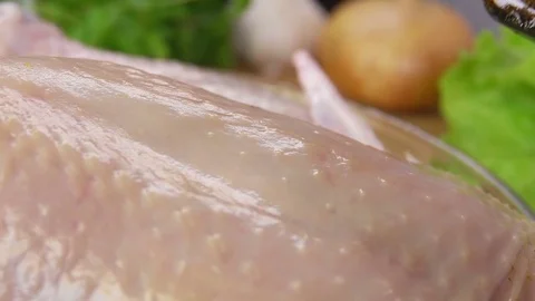 Pouring the marinade on the chicken Stock Footage 70415777