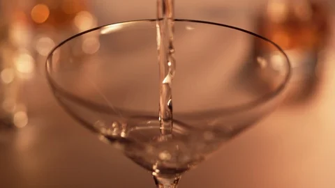 Pouring martini into empty glass. Slow Motion. Stock Footage 128962860