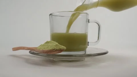 Pouring matcha or green tea into a glass cup Stock Footage 278017976