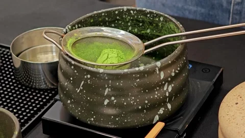 Pouring matcha powder into a sifter. Stock Footage 304437036