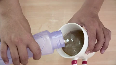 Pouring medium hot frothy milk, making homemade hot coffee latte Stock Footage 145704377
