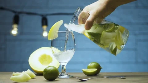 Pouring melon lemonade into a glass Stock Footage 142884919