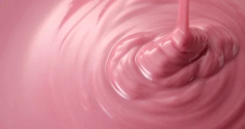 Pouring melt ruby chocolate. Closeup shot. Video stock 127613860