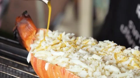 Pouring Melted Cheese Sauce onto Grilled Giant Lobster Shell Filled with Meat Stockbeeldmateriaal 344232014