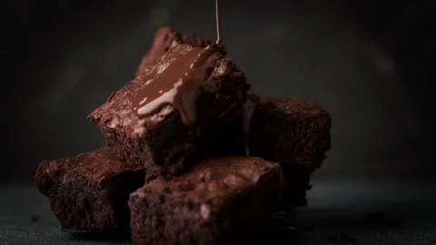 Pouring melted chocolate on cake biscuits in a slow motion Stock Footage 198395672