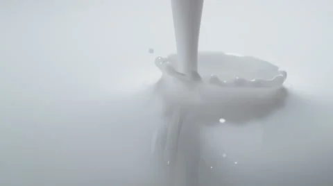 Pouring milk and making splash. Slow Motion. Stock Footage 60965917