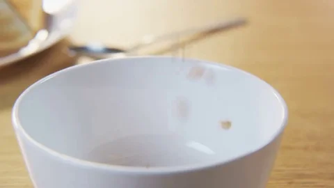 Pouring Milk into a Bowl with Cornflakes Stock Footage 69203230