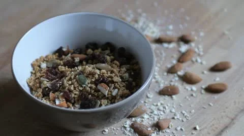 Pouring milk in a bowl with granola Stock Footage