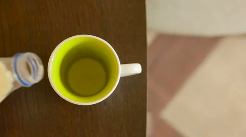 Pouring milk in a ceramic mug. view from above Stock Footage 67808187