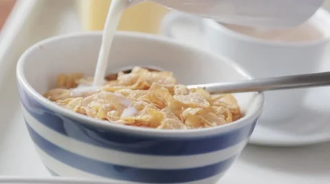 Pouring milk on cereal Stock Footage 7730422