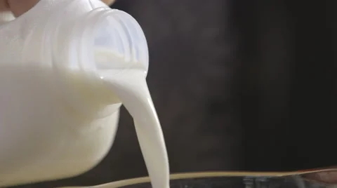 Pouring milk; close-up Stock Footage 64025276