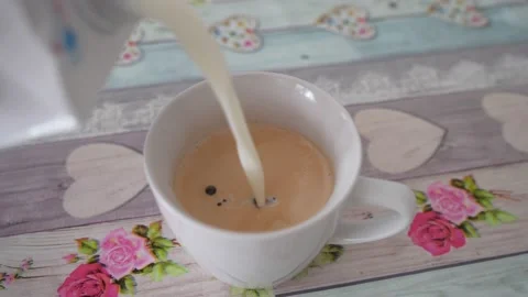 Pouring milk into coffee close up Stock Footage 223527087