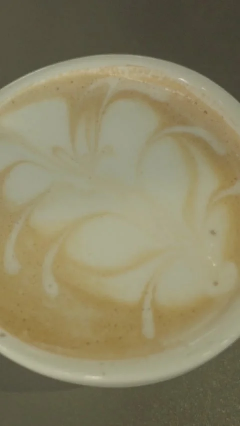 Pouring Milk Into Coffee Creating Latte Art Foam Pattern in Cup Close Up Scene Stock Footage 336375690
